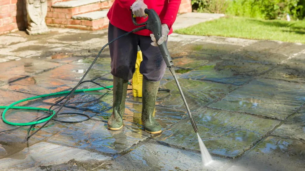 Person Pressure Washing Patio House